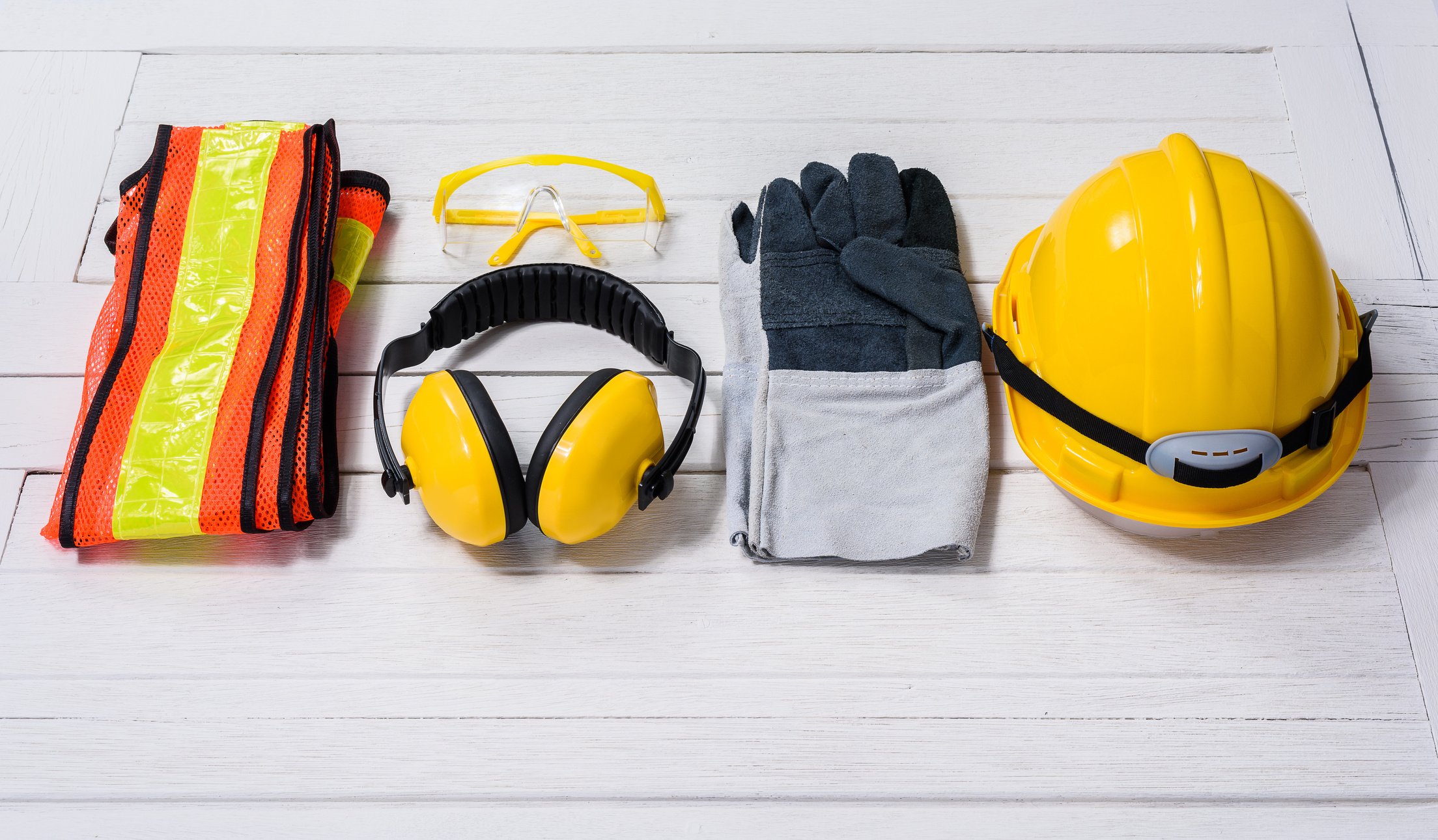 Standard construction safety equipment on wooden table